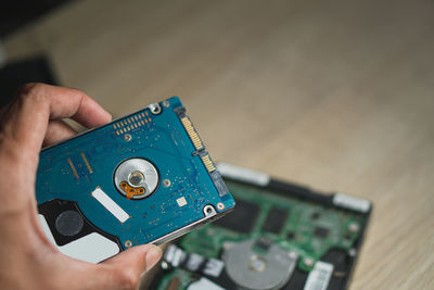 Cropped hand of person holding circuit board