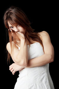 Midsection of woman against black background