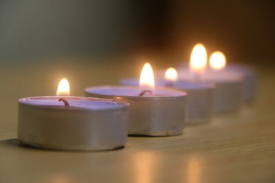 Close-up of lit candles on table