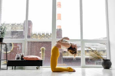 Side view of woman walking through window