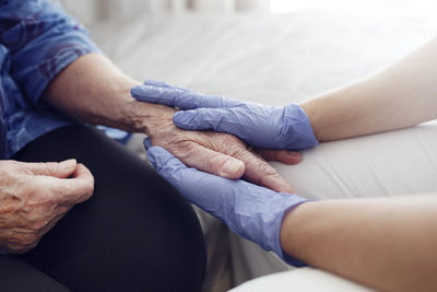 Nurse holding woman's hand