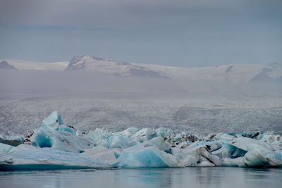 Scenic view of landscape against sky during winter