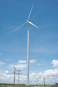 Wind turbines against sky