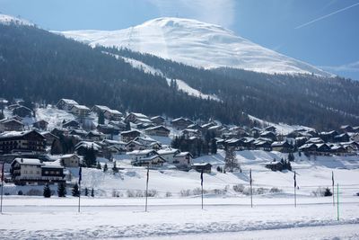 Snow covered land and mountains against sky