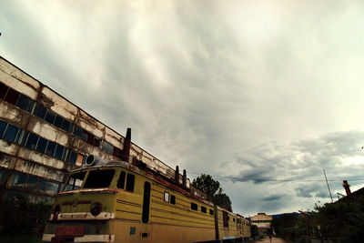 Low angle view of building against cloudy sky