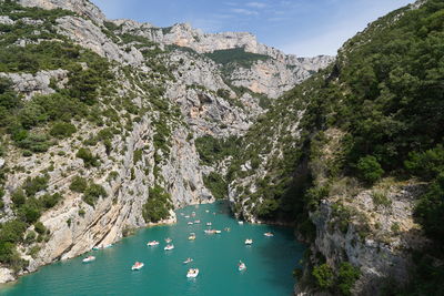 Panoramic view of river with pedal boats at verdon canyon amidst trees against sky