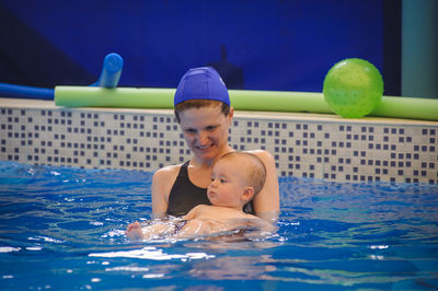 Portrait of boy swimming in pool