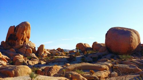 Rock formation against clear blue sky