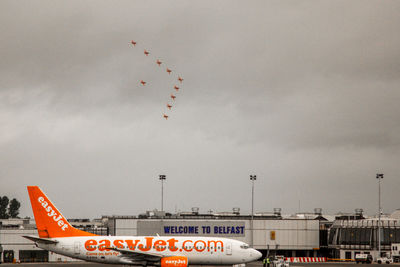 Low angle view of airplane flying against sky