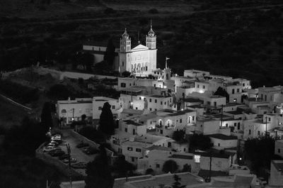 High angle view of city lit up at night