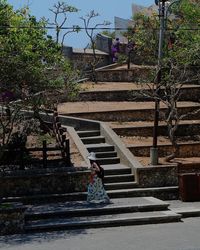 Woman on staircase of building