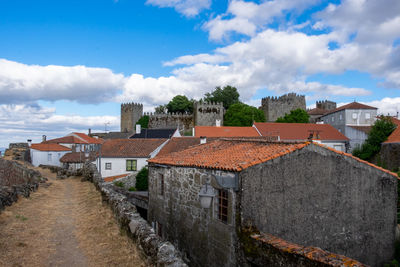 High angle view of buildings in town against sky