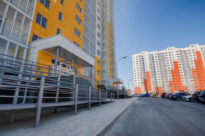 Street amidst buildings against sky in city