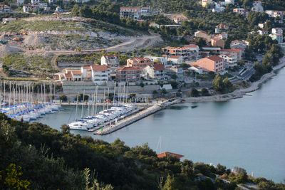 High angle view of harbor at sea by buildings