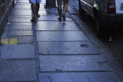 Low section of people walking on street