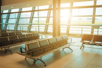 Empty chairs and tables in tiled floor