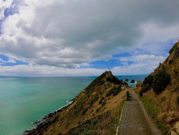 Panoramic view of road by sea against sky