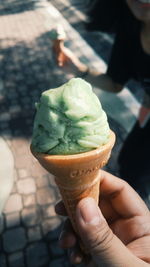 Cropped image of hand holding ice cream cone