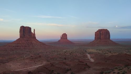 Scenic view of desert against sky during sunset