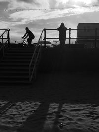 Silhouette of man walking on steps