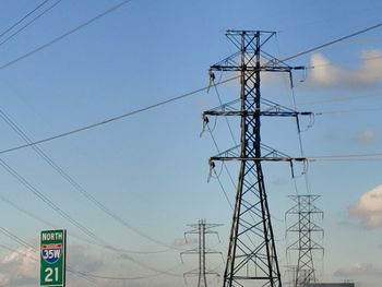 Low angle view of electricity pylon against sky