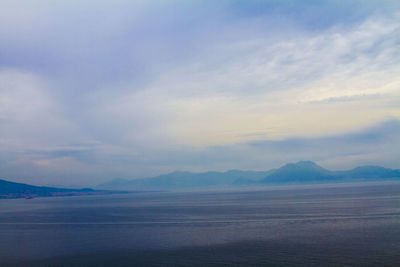 Scenic view of mountains against cloudy sky