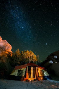 View of illuminated tent against sky at night