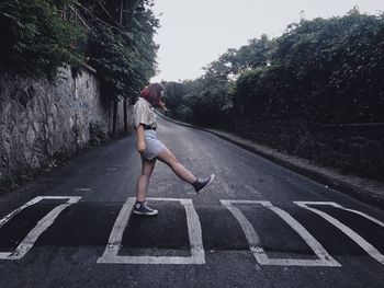 Full length of woman on road