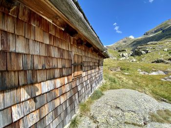 Low angle view of building by mountain against sky