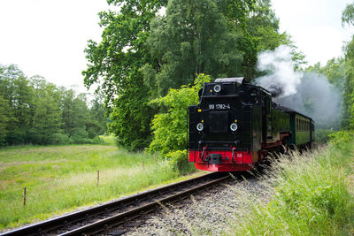 Train on railroad track against sky