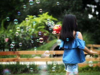 Woman with bubbles in park