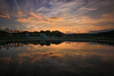 Scenic view of lake against romantic sky at sunset