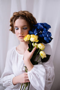 Portrait of young woman with bouquet