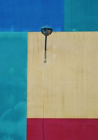 Close-up of electric lamp by swimming pool