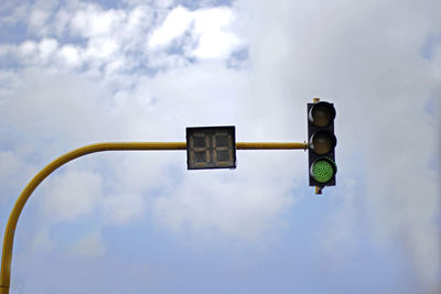 Low angle view of green light against sky