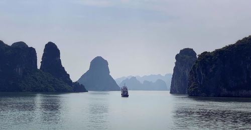 Scenic view of sea and mountains against sky