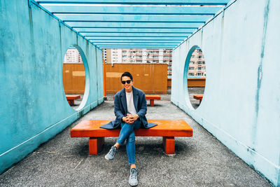 Portrait of young man sitting on mobile phone