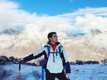 Full length of man standing on mountain against sky