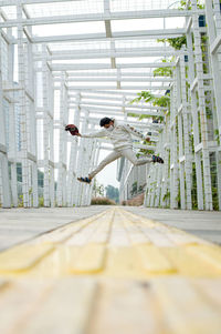 Side view of man standing on walkway