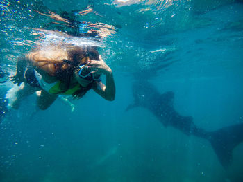 Woman swimming undersea