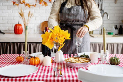 Midsection of woman having food at home