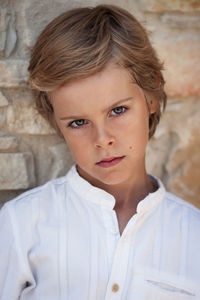 Portrait of boy against wall