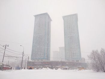 View of city against clear sky during winter