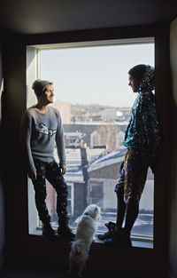 Young men standing in a window