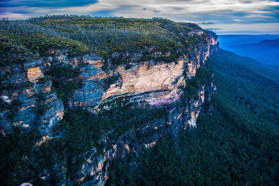 Panoramic view of rock formation in sea against sky