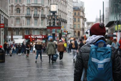 Rear view of people in city