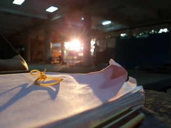 Close-up of rubber bands on book in brightly lit library