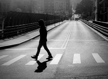 Rear view of man walking on railroad station