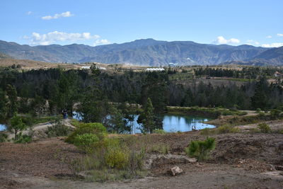 Scenic view of lake and mountains against sky