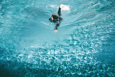 High angle view of man swimming in pool